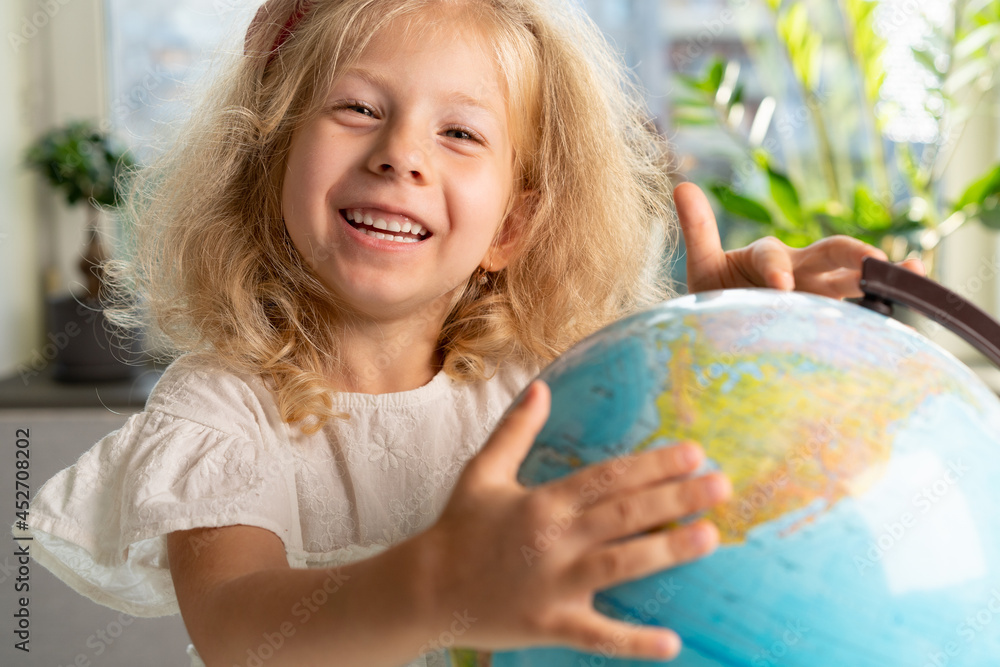 little girl with a globe, study geography, back to school little girl with a globe, study geography, back to school