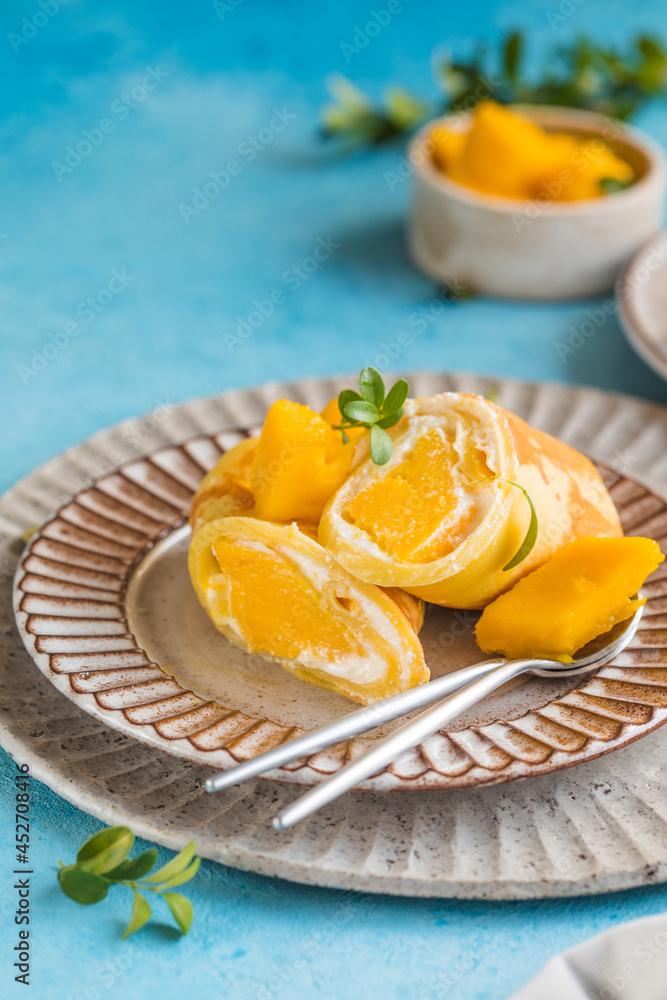 Sticky rice and mango crepe cake roll , .Hong Kong , Thai food style in summer Sticky rice and mango crepe cake roll , .Hong Kong , Thai food style in summer