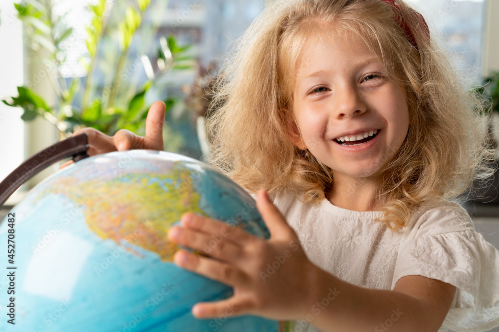 little girl with a globe, study geography, back to school little girl with a globe, study geography, back to school