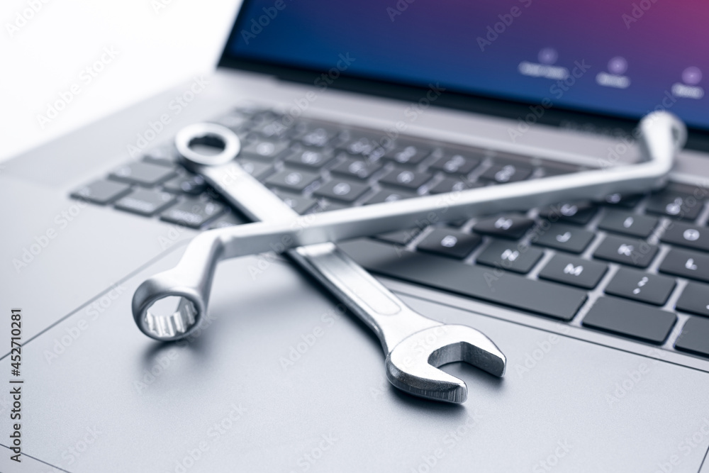 Fototapeta premium Computer fixing, service or maintenance concept background. Working tools on modern laptop computer