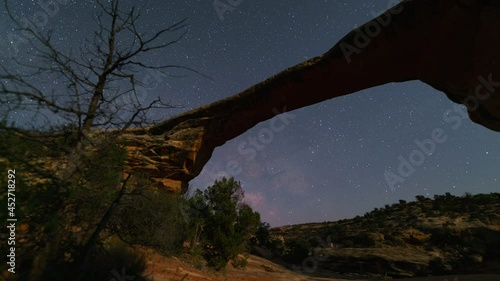 Time lapse tracking shot of Milky Way galaxy over Owachomo Bridge at Natural Bridges National Monument, Utah photo