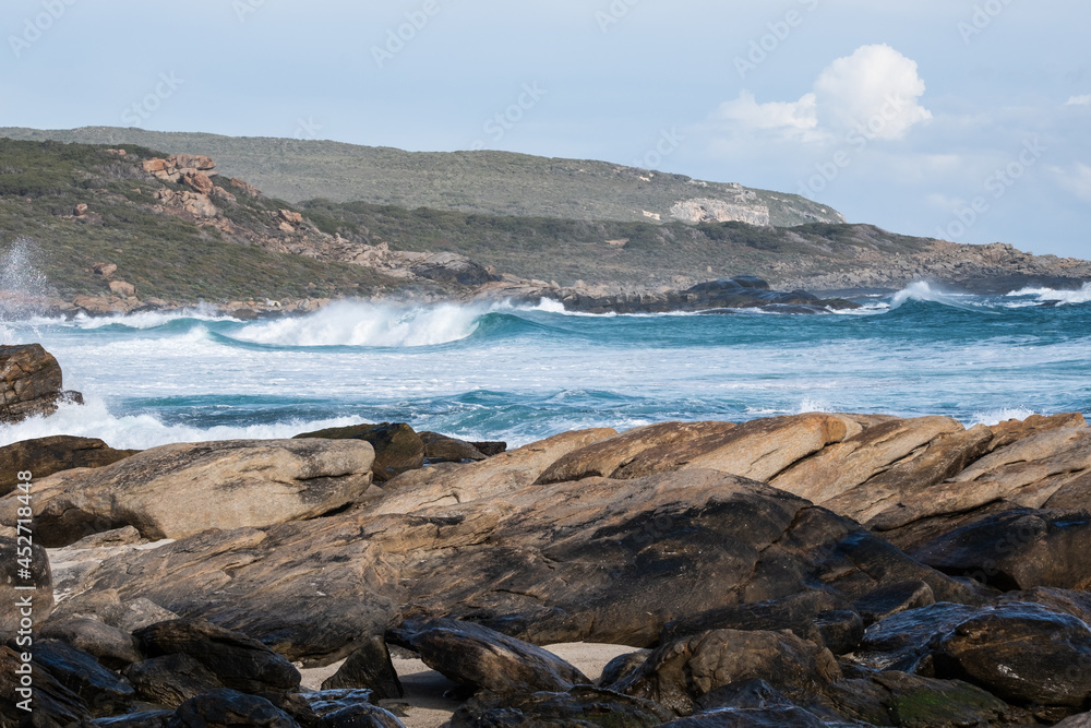 Looking south over rocks to waves at Redgate Surf break, Western Australia
