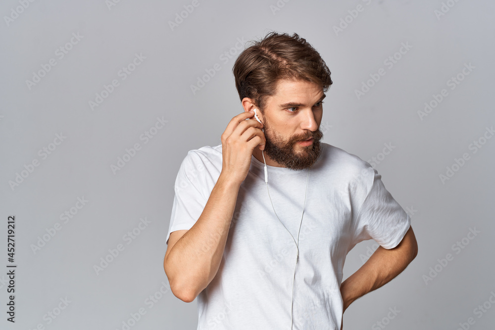 man in white t-shirt with beard lifestyle casual wear Studio light background man in white t-shirt with beard lifestyle casual wear Studio light background