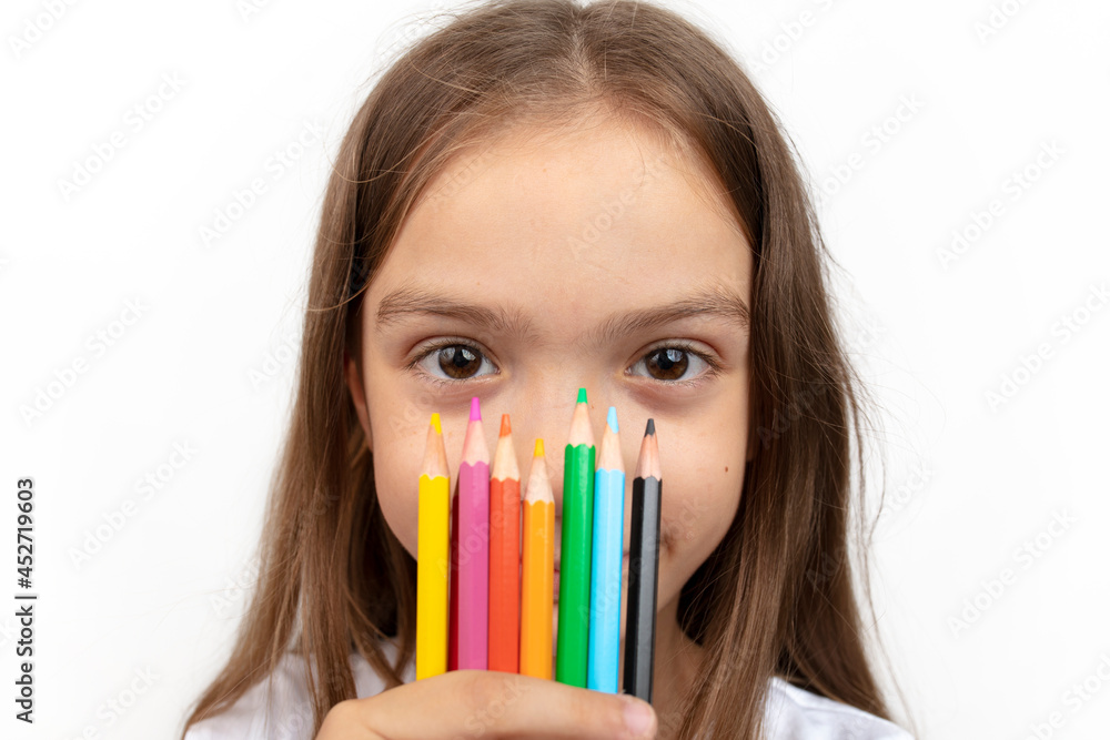 education, creativity, people, kids and school concept. Little student girl showing colorful crayons on white background. education, creativity, people, kids and school concept. Little student girl showing colorful crayons on white background.