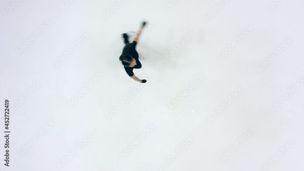 Female skater is performing spinning elements in a top view Female skater is performing spinning elements in a top view