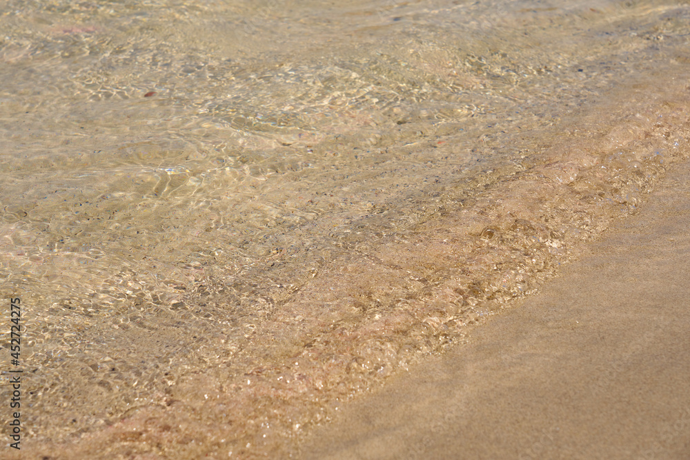 Clear waves and colorful sand on tropical sandy beach in Crete Greece. Clear waves and colorful sand on tropical sandy beach in Crete Greece.