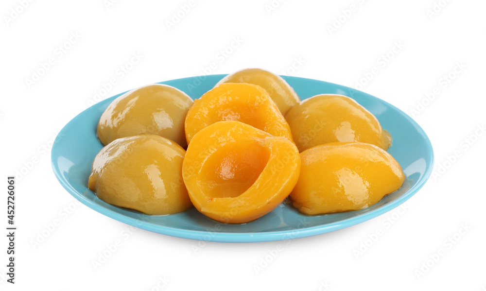 Plate with canned peach halves isolated on white