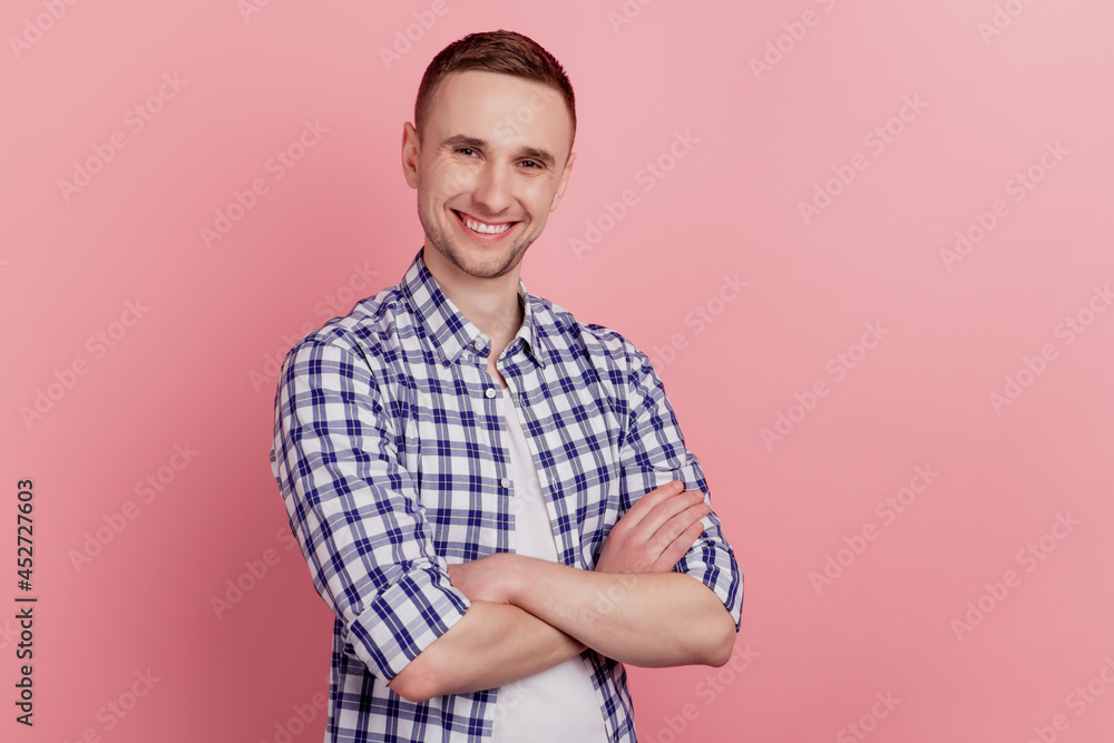 Profile side photo of attractive young man standing with folded arms confident happy smile fun isolated on pink color background Profile side photo of attractive young man standing with folded arms confident happy smile fun isolated on pink color background