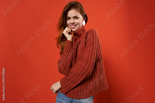 cheerful woman in a red sweater makeup earrings fashion studio
