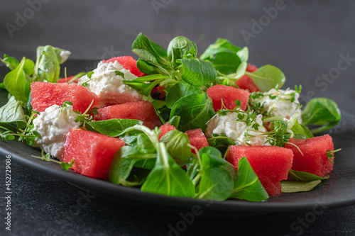 Healthy protein snack for fitness or healthy eating with fresh cut watermelon with cottage cheese and salad