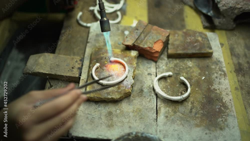Jeweler at work in jewelry. Desktop for craft jewelry making with professional tools. Close up view of tools. Thailand. Jeweler at work in jewelry. Desktop for craft jewelry making with professional tools. Close up view of tools. Thailand.