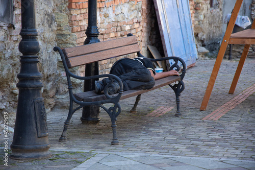 homeless man  sleeps on a bench in Bistrita, Romania,august 2021 photo