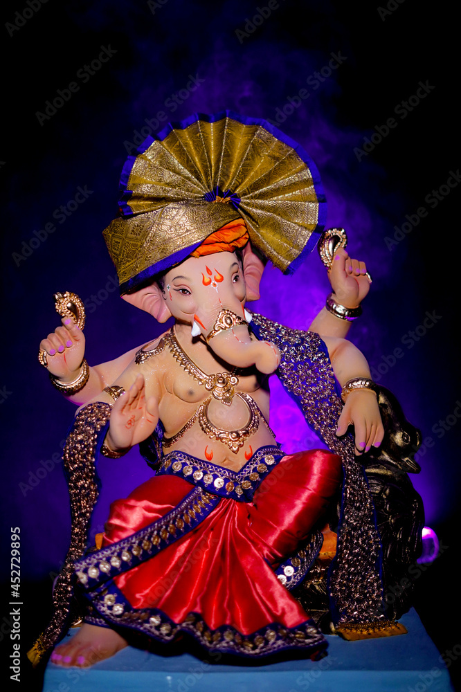 Lord Ganesha, Hindu god Ganesh on black background with a smoke of incense