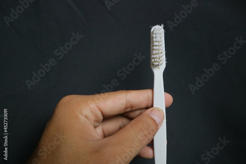 used toothbrush for cleaning teeth on isolated background