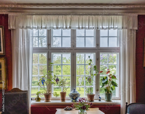 Fototapeta Naklejka Na Ścianę i Meble -  Vintage old traditional window sill with flowers and pots