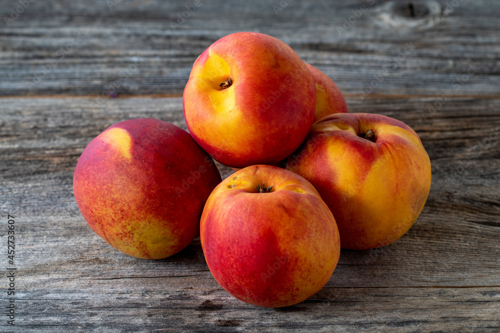 Vivid peaches and nectarines on wood floor Vivid peaches and nectarines on wood floor