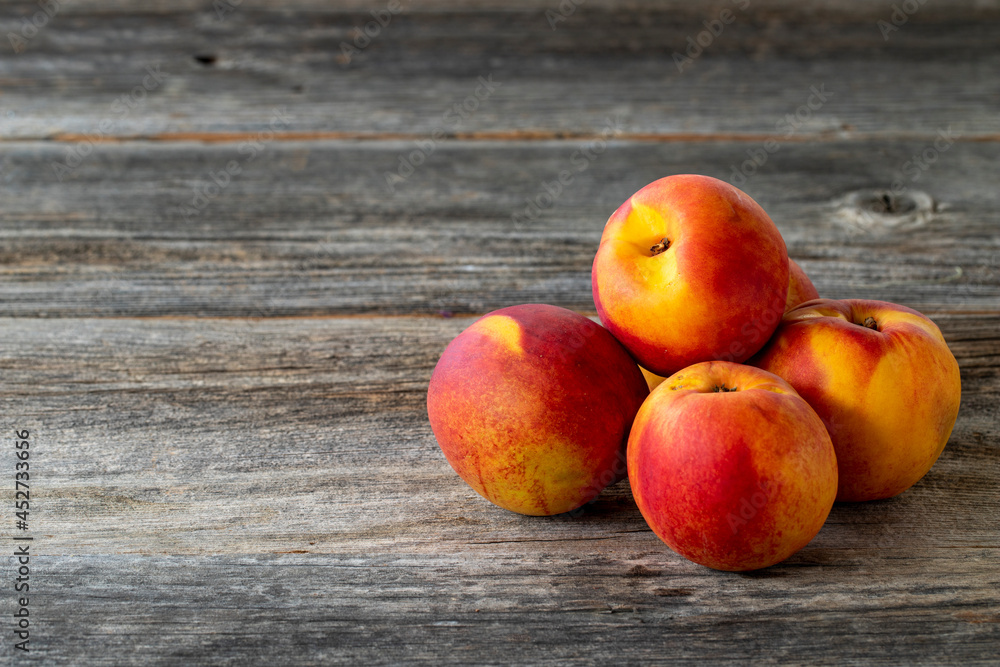 Vivid peaches and nectarines on wood background. Copy space Vivid peaches and nectarines on wood background. Copy space