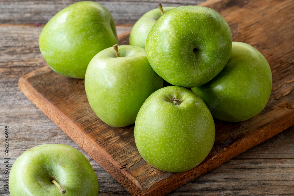 fresh green apple (sour apple) on wood background. Close up fresh green apple (sour apple) on wood background. Close up