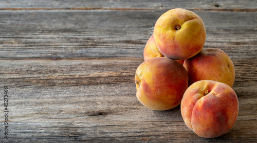 fresh peaches on wood background. Copy space