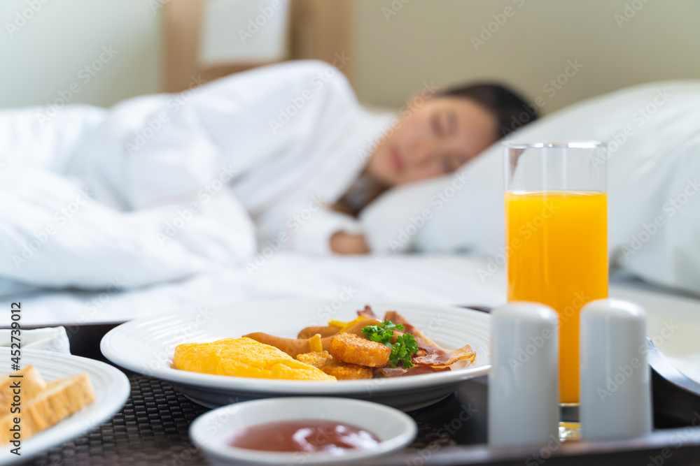 Breakfast in bed. Woman sleeping on the bed wake up late