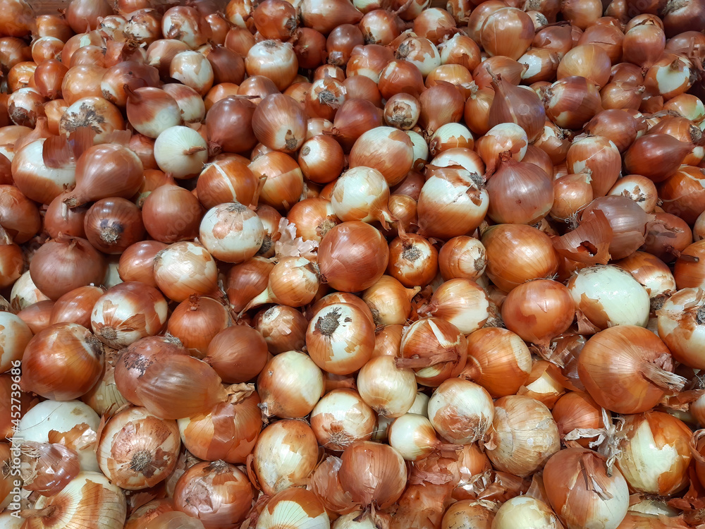 White onion. Pile of bulbs for sale on farming market. Vegetables background White onion. Pile of bulbs for sale on farming market. Vegetables background