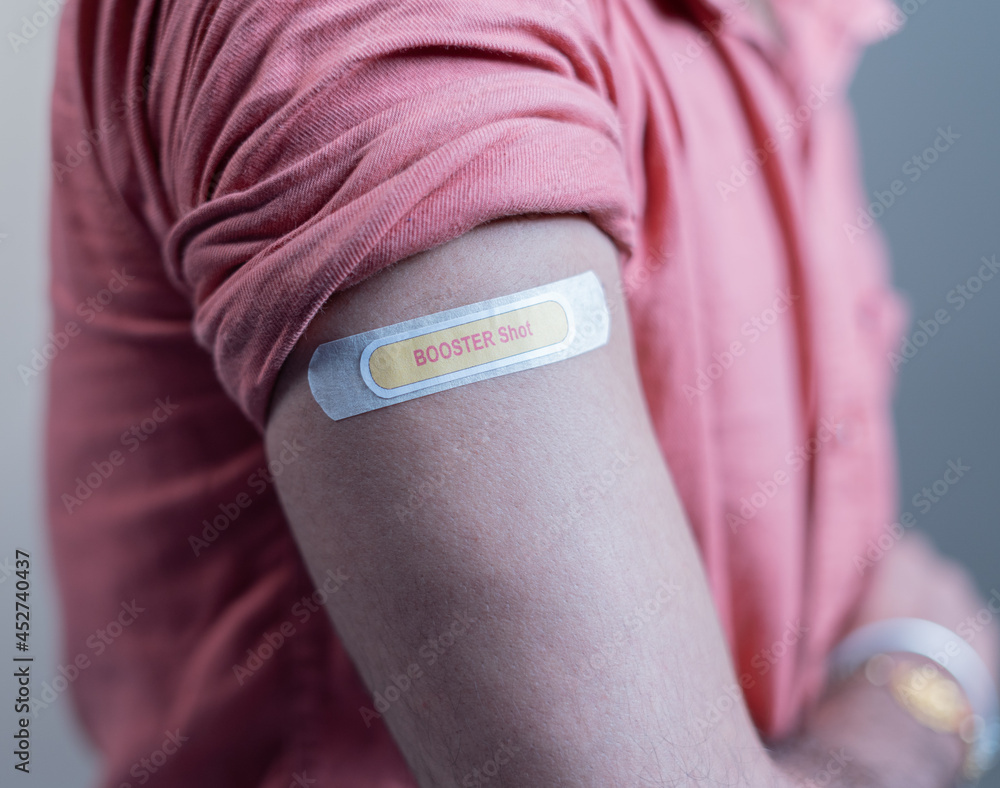 covid-19 or coronavirus vaccinated shoulder with booster shot sticker - concept of coronavirus 3rd dose vaccination. - obrazy, fototapety, plakaty 