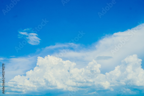 huge White fluffy cloud against blue sky summer background © Parichart