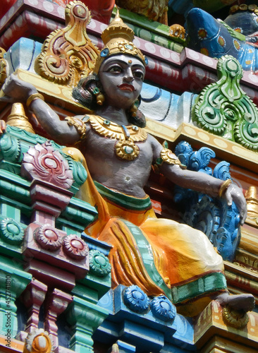 view of Indian Hindu God statue on the temple tower or gopuram