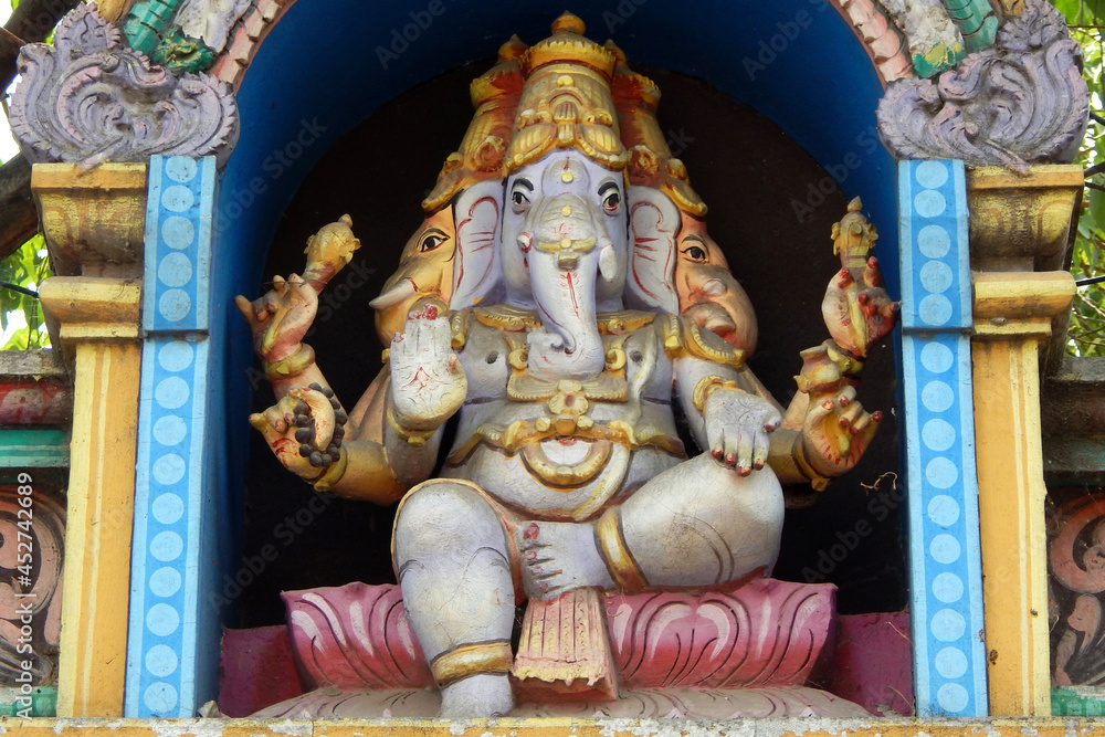 view of Indian Hindu God Ganesha statue on the temple tower or gopuram