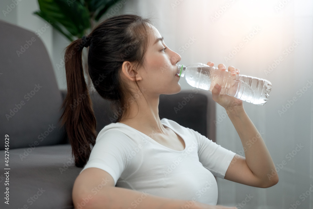 woman drinking water after exercise to fill dehydration woman drinking water after exercise to fill dehydration