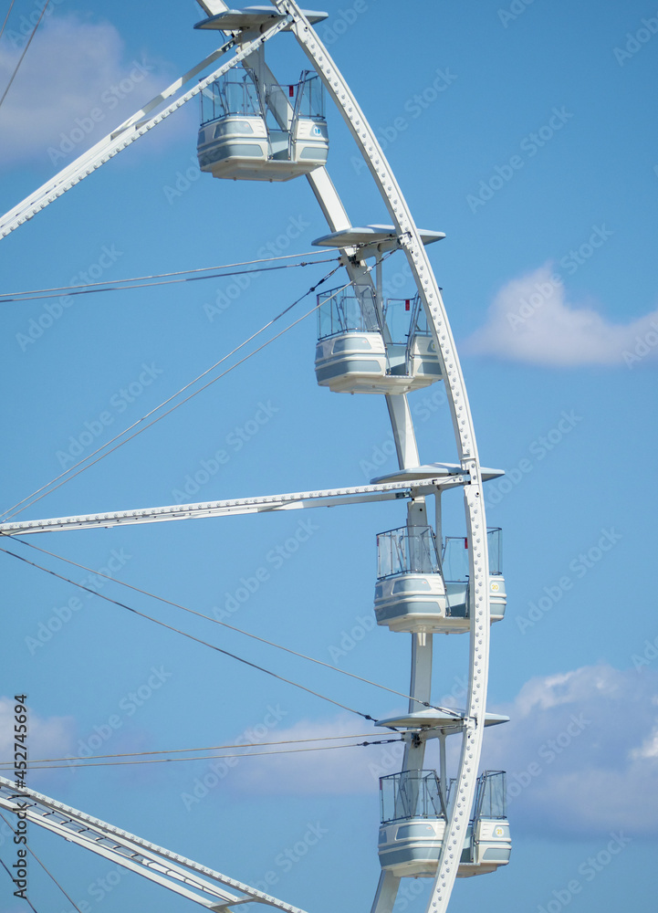 Ferris wheel detail with blue sky background.