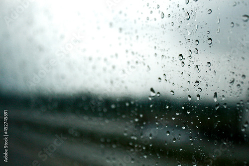 drop,rain,wet,window,raindrop,dew,water,background,droplet,liquid,sparse,transparent,clear,condensation,freshness,clean,glass,pattern,bubble,drip,effect,reflection,shiny,storm,textured,weather,gray,su