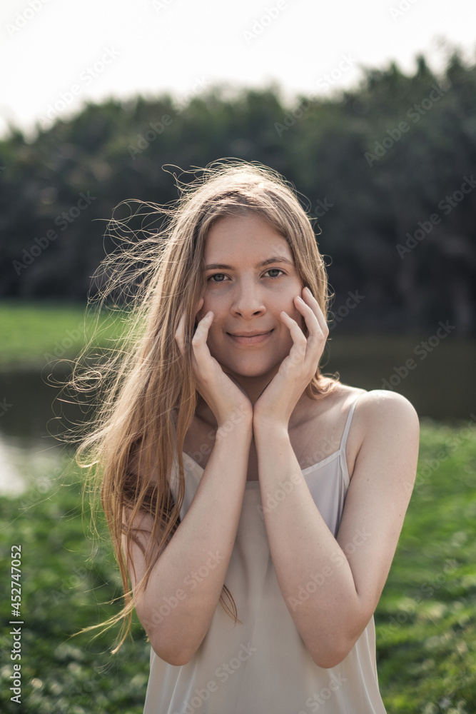 Portrait of Young caucasian woman. Beauty Girl without Makeup in White dress. Natural Skin Beauty. Long blond hair. Natural beauty without make-up 