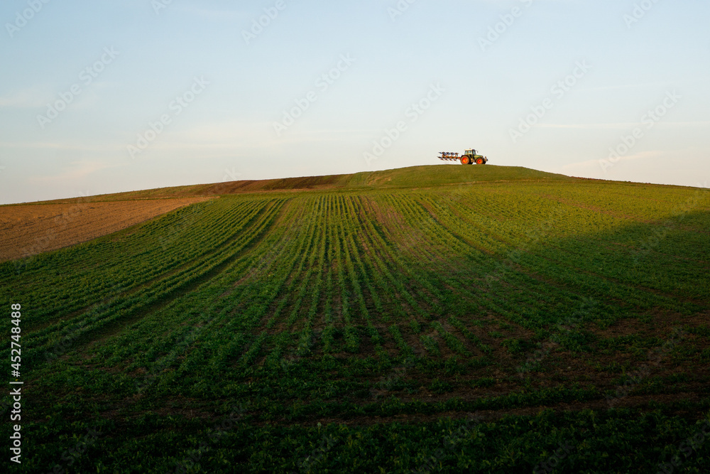 tractor in field on a hill in Germany tractor in field on a hill in Germany