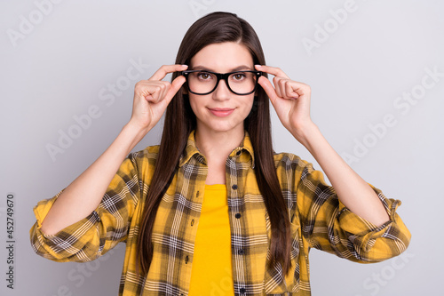 Photo of charming sweet young lady wear plaid shirt arms glasses smiling isolated grey color background