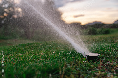 Irrigation system sprinkles the golf course