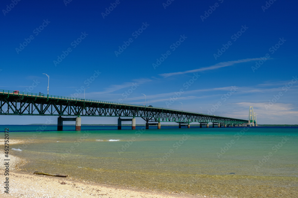 The colorful and clear waters of the straits of Mackinac and the Mackinac Bridge connecting the Upper and Lower Peninsula of Michigan The colorful and clear waters of the straits of Mackinac and the Mackinac Bridge connecting the Upper and Lower Peninsula of Michigan
