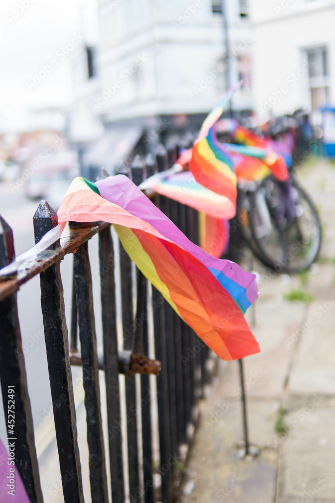 Group of LGTB flags waving on a balcony in the streets of UK.