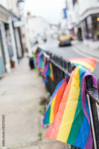 Group of LGTB flags waving on a balcony in the streets of UK.