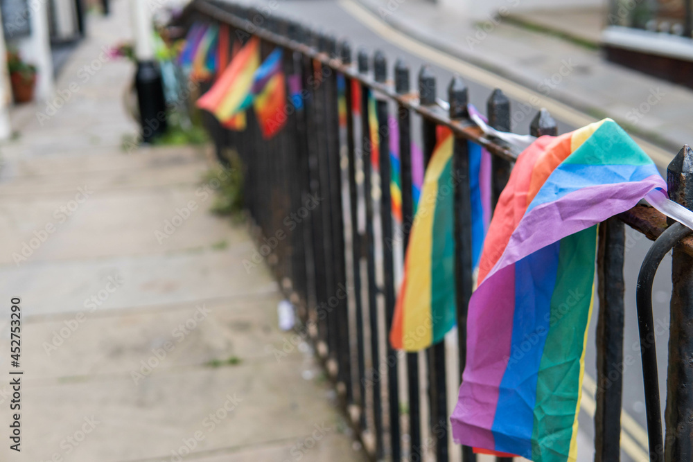 Group of LGTB flags waving on a balcony in the streets of UK.