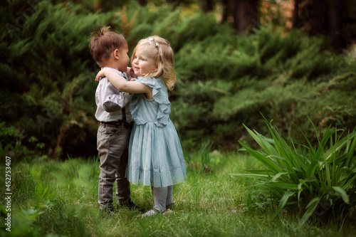 little boy and girl friends hug