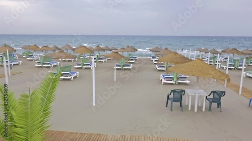 Several Rows Of Beach Umbrellas Straw, .Camera slowly moving through beautiful beach with umbrellas and sunbeds. Perfect summer vacation destination : 