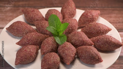 Traditional kebbe on turntable in lebanese restaurant, High quality 4k footage photo