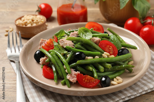 Tasty salad with green beans served on wooden table