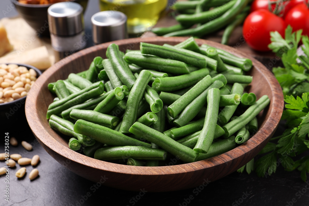 Fresh raw green beans and other ingredients for salad on table, closeup Fresh raw green beans and other ingredients for salad on table, closeup