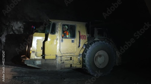 Underground truck loaded with ore rides in an underground mine