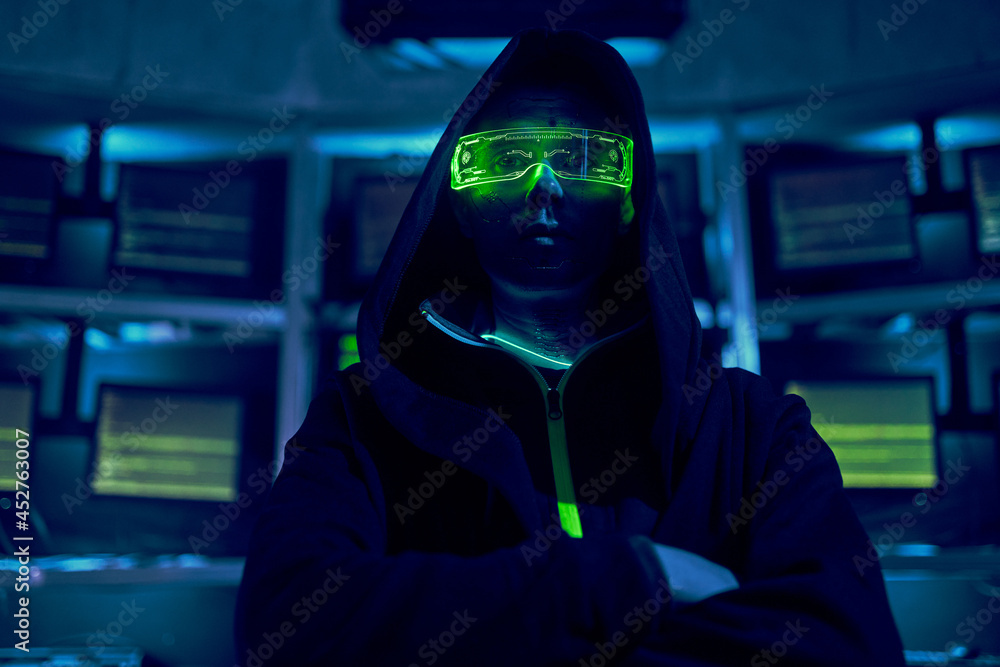 Portrait of a cyber hacker stealing information using a computer. Portrait of a cyber hacker stealing information using a computer.