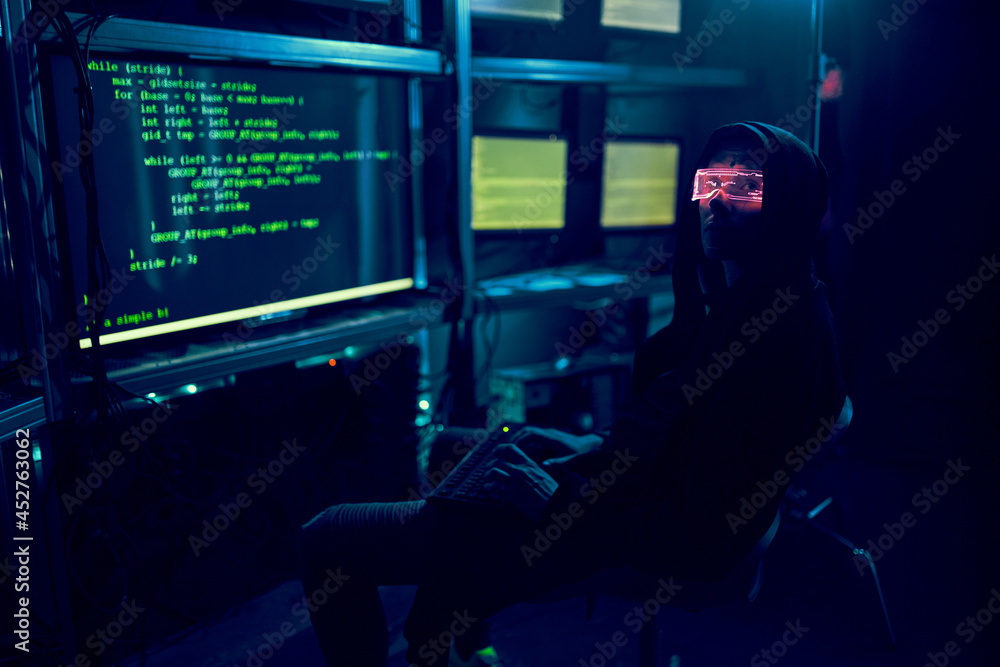 Cyber hacker breaks into databases to obtain information using a computer. Cyber hacker breaks into databases to obtain information using a computer.