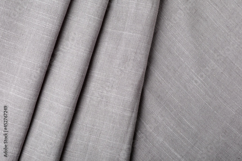 Grey hemp cloth as background, top view. Natural fabric