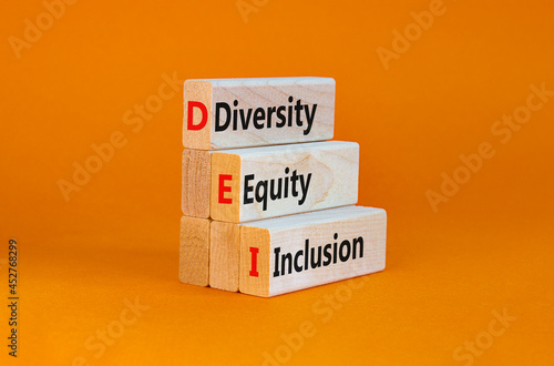 DEI, Diversity, equity, inclusion symbol. Wooden blocks with words DEI, diversity, equity, inclusion on beautiful orange background. Business, DEI, diversity, equity, inclusion concept. photo